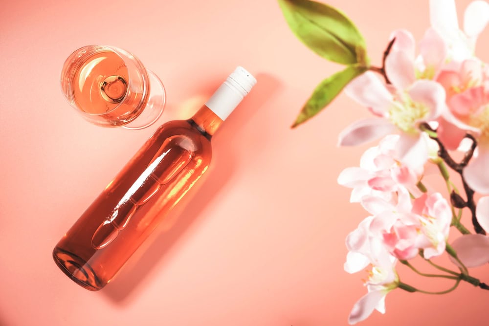 Rosé wine in a bottle with pink flowers